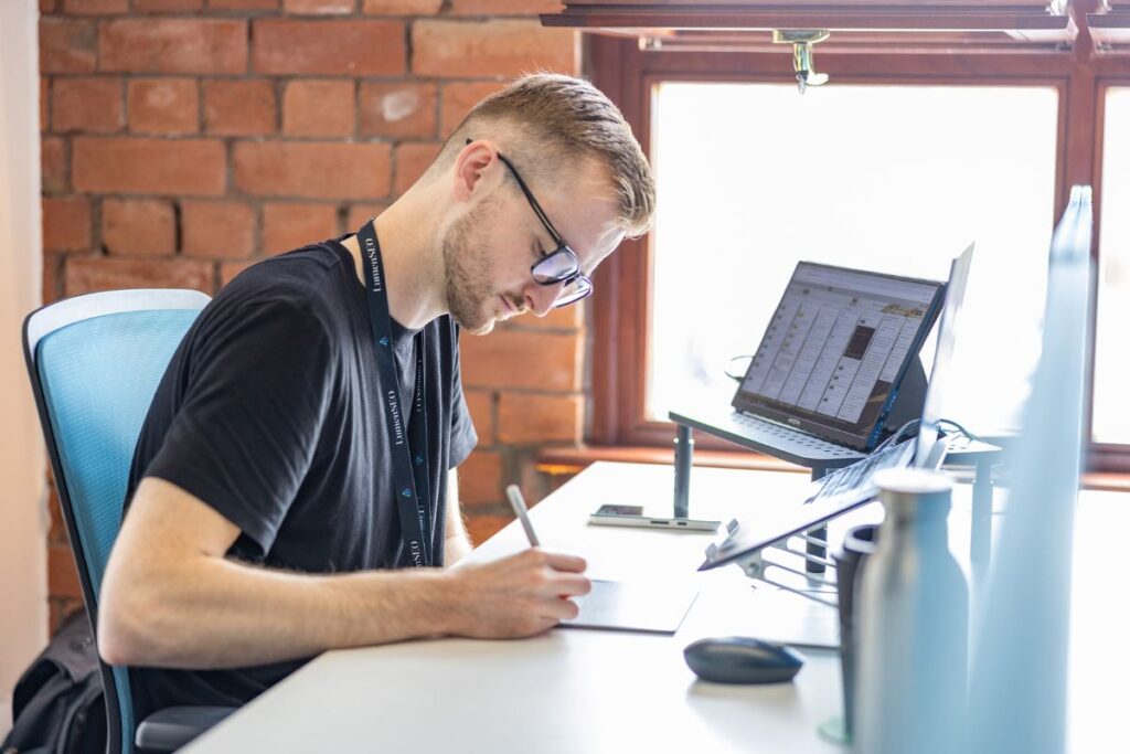 Aled working at the computer in the Lumen office.
